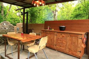 a wooden table and chairs on a patio at Stay Hovq in Dilijan