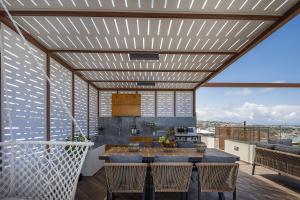 a kitchen and dining room with a wooden ceiling at Amaltheia Luxury Residence in Rethymno Town +88 photos
