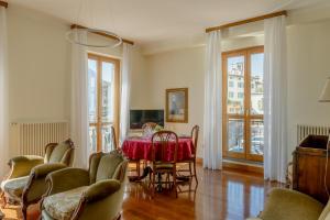 a dining room with a red table and chairs at Casa MAMMA in Lovere