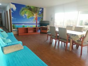 a living room with a table and chairs and a couch at Mis Princesas en casa in Chiclana de la Frontera