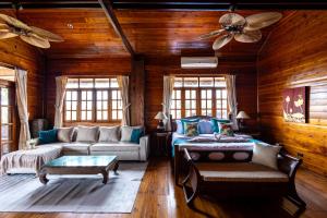 a living room with a couch and a ceiling fan at Luxury Villa Miramar Orchid House Samui in Amphoe Koh Samui