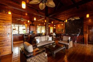 a living room with a couch and a table at Luxury Villa Miramar Orchid House Samui in Amphoe Koh Samui +60 photos