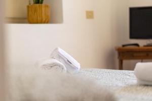 a pile of towels sitting on top of a bed at Sea Soul Positano in Positano