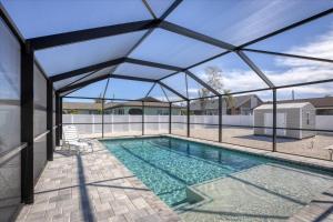 a swimming pool with a retractable roof at 1 BR, Heated POOL, 1 Mile direct gulf access, GREAT Location, Dockage Apt B in Englewood
