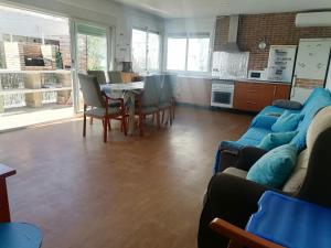 a living room with a couch and a table and chairs at Mis Princesas en casa in Chiclana de la Frontera +16 photos