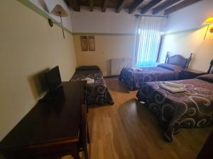 Postel nebo postele na pokoji v ubytování Hostal Las Nieves