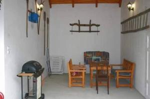 a dining room with chairs and a table and a table and chairsktop at Anna Falusi Vendégház Sarud in Sarud