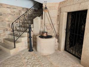 a stone staircase with a pot next to a door at Casa do Poço in Miranda do Douro +78 photos