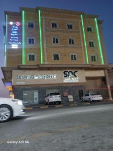 a building with cars parked in front of it at العييري للشقق المخدومة الدمام 8 in Dammam