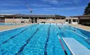 a large swimming pool with blue water at Camping de Charlieu in Charlieu