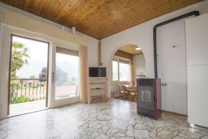 a living room with a large window and a television at Buena Vista in Germignaga