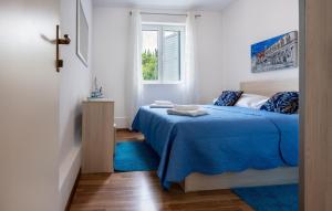 a bedroom with a blue bed and a window at Apartman Marija Slano by Villas Guide in Slano