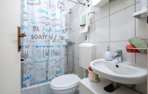 a bathroom with a toilet and a sink and a shower curtain at Apartman Marija Slano by Villas Guide in Slano +14 photos