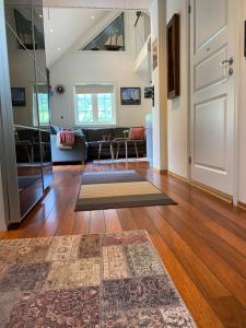 a living room with a door and a rug on the floor at Sea Front Olden in Olden +37 photos