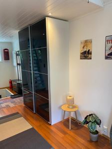 a glass partition in a room with a table and a chair at Sea Front Olden in Olden