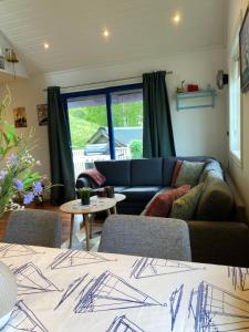 a living room with a couch and a table at Sea Front Olden in Olden