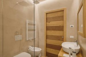 a bathroom with a toilet and a sink and a shower at Hotel Le Mura in Lazise