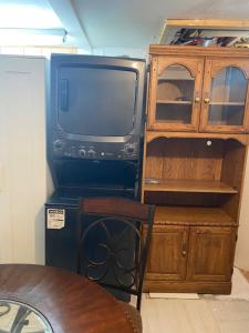 a tv sitting next to a wooden cabinet at Peace and Comfort 1-bedroom basement Apartment in Brampton
