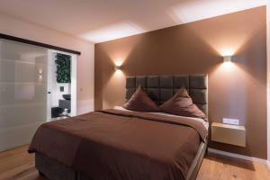 a bedroom with a bed with two lights on it at Boutiquehotel Reuter GmbH in Hattingen