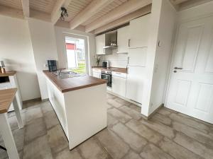 a kitchen with white cabinets and a counter top at Ferienhaus Emily in Nordhorn