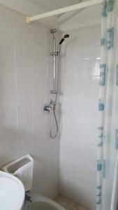a bathroom with a shower with a toilet and a sink at Hotel Al Sogno in Alassio +15 photos