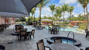 a patio with tables and chairs next to a pool at Apartamentos Lagoa Quente Hotel in Caldas Novas