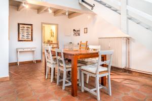 a dining room with a wooden table and chairs at Nordseetraum in Garding