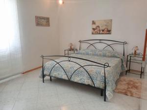 a bedroom with a bed and two night stands at ai Confini in Castelnuovo di Val di Cecina