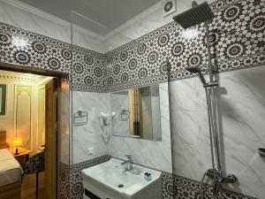 a bathroom with a sink and a shower at Ornament Boutique Hotel in Khiva +22 photos