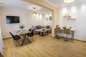 a living room with a table and a couch at Mastiha Luxury Suites in Chios