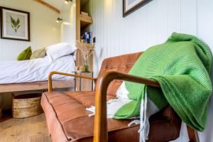 a living room with a couch and a bed at Hintock in Sherborne