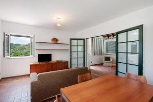 a living room with a couch and a table at Villa Zafferano in Celle Ligure