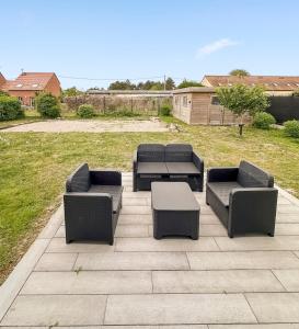 four chairs and a table on a patio at Bois Lurette - Stella-Plage - Maison proche plage et centre-ville in Cucq