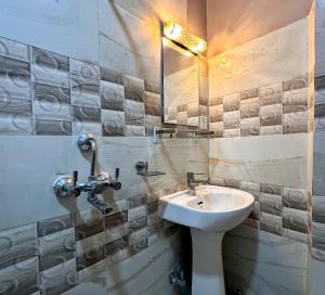 a bathroom with a sink and a mirror at Amigo Studio Inn Pokhara in Pokhara +23 photos