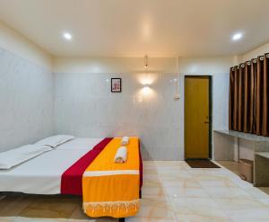 Uma cama ou camas num quarto em Prakash Regency, Satara