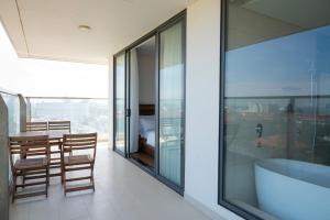 a bathroom with a tub and a table with chairs at Thy Hung legacy hotel in Tuy Hoa +132 photos