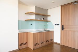 a kitchen with a sink and a counter top at Thy Hung legacy hotel in Tuy Hoa