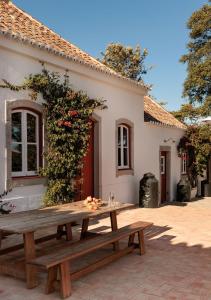 a picnic table in front of a house at Quinta do Pinheiro in Pinheiro