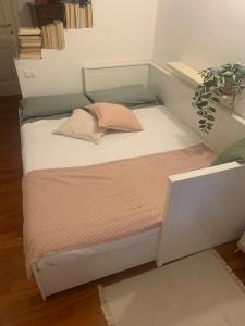 a small bed with a pillow on it in a room at Vicolo Castellaccio in Massa