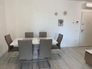 a dining room with a white table and chairs at QUEEN HOME Luana in Venice +11 photos