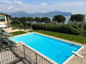 a swimming pool with a view of the water at Appartamento vista Lago Sarnico in Sarnico