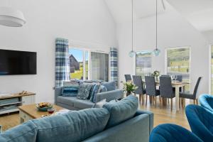 a living room with a couch and a dining room at No 2 The Vista, Willingcott, Woolacombe in Woolacombe