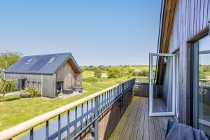 a balcony with a view of a barn at No 2 The Vista, Willingcott, Woolacombe in Woolacombe