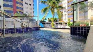 a swimming pool in the middle of a building at Apartamentos Thermas do Bandeirante in Caldas Novas