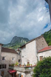 a group of buildings with a mountain in the background at Modern Design Old Town Apartment by MN Property in Kotor