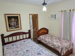 a bedroom with two beds and a picture on the wall at Apartamentos Thermas do Bandeirante in Caldas Novas +68 photos