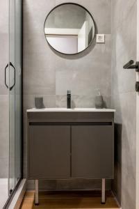 a bathroom with a sink and a mirror at Modern Design Old Town Apartment by MN Property in Kotor