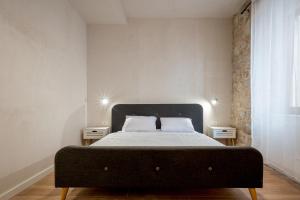 a bedroom with a large bed with two night stands at Modern Design Old Town Apartment by MN Property in Kotor
