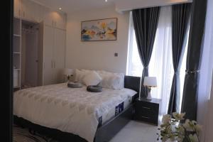 una camera da letto con un letto con due cuscini sopra di Nisrab Apartments Najjera Kampala a Kampala