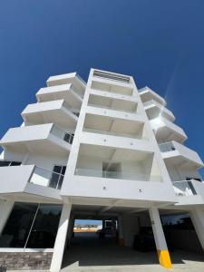 a white building with a lot of windows at Antonios Miramar Hotel in Ciudad Madero